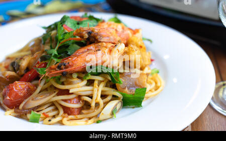 close up side view spicy spaghetti stir fried seafood Thai food, tum yum talay Stock Photo