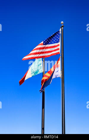 Mexican, American and Arizona state Flags at the Border between the two countries Stock Photo