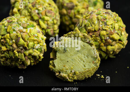 Theme sweet dessert cake handmade. Macro close-up dessert dessert sweet candy round ball white truffle ball set of white chocolate, matcha tea and pis Stock Photo