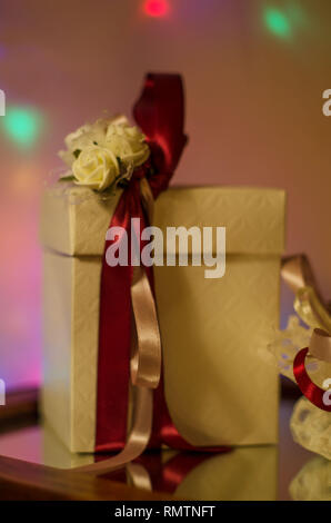 gifts from wedding confetties with candies beautifully wrap with flowers and red white ribbons also with white boxes taken with good closeup angles pr Stock Photo