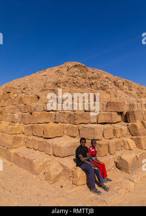 Sudanese children sit on a pyramid in the royal cemetery, Northern State, El-Kurru, Sudan Stock Photo