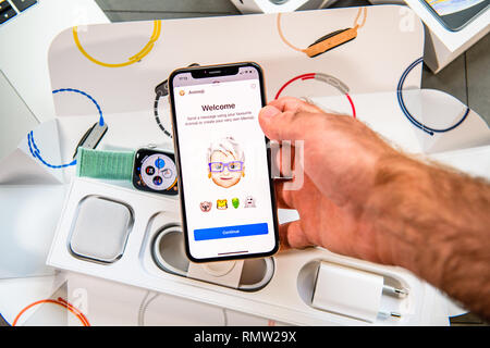 PARIS, FRANCE - SEP 24, 2018: Unboxing of iPhone Xs Max with demonstration of Messaging App with new Animoji Memoji features characters - augmented reality communication create very own Stock Photo