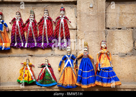 Colorful Rajasthan puppets hanging in the shop of Jaisalmer City Palace, India Stock Photo