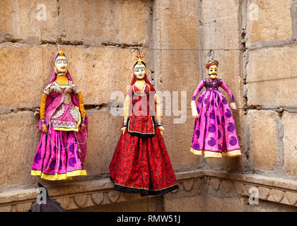 Colorful Rajasthan puppets hanging in the shop of Jaisalmer City Palace, India Stock Photo