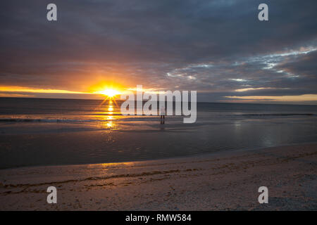 Man fishes along Tigertail Beach at sunset on Marco Island, Florida Stock Photo