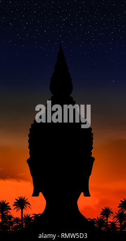 The black outline of Buddha head on color background with stars on heaven.The dark head silhouette with historical helmet with sunset and palm trees. Stock Photo