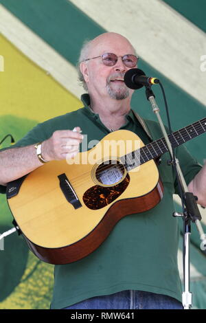 Folk singer and songwriter Tom Paxton is shown performing on stage during a 'live' concert appearance. Stock Photo