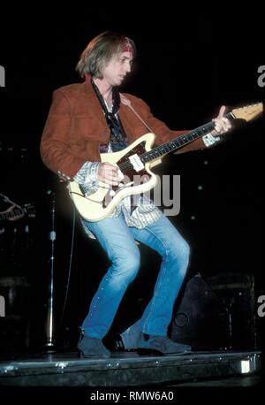 Singer, songwriter and multi-instrumentalist Tom Petty is shown performing on stage during a "live" concert appearance. Stock Photo