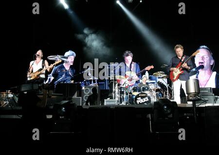 The Police, featuring Sting, Andy Summers and Stewart Copeland, are shown performing on stage during a 'live' concert appearance. Stock Photo