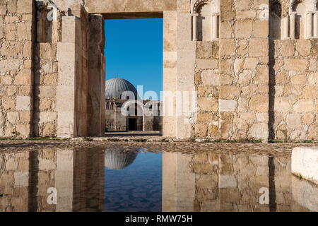 Ancient architecture with reflection on the water at Citadel in Amman, Jordan Stock Photo