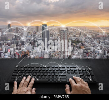 Internet networking and connection, Hand typing digital keyboard and city sunrise Stock Photo