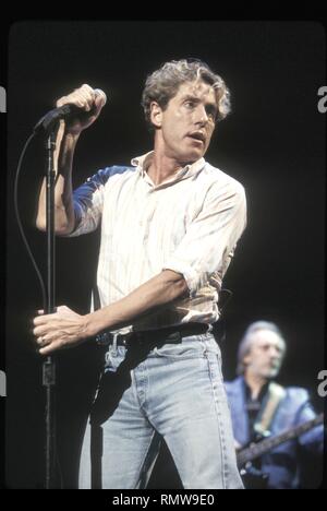 Lead singer Roger Daltrey of the rock band The Who is shown performing on stage during a 'live' concert appearance. Stock Photo