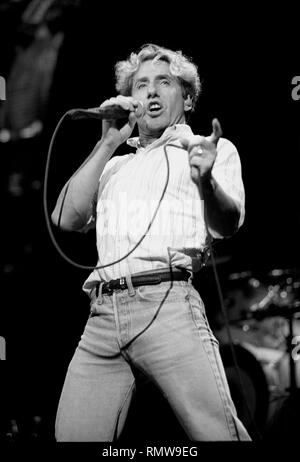 Lead singer Roger Daltrey of the rock band The Who is shown performing on stage during a 'live' concert appearance. Stock Photo