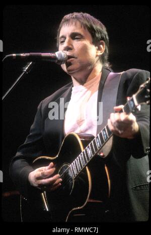 Singer, songwriter and musician Paul Simon, perhaps best known for his partnership with Art Garfunkel in the duo Simon & Garfunkel. is shown performing on stage during a concert with his solo band. Stock Photo