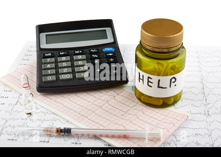 Plastic bottle with pills, syringe and calculator on cardiogram. Isolated. Stock Photo