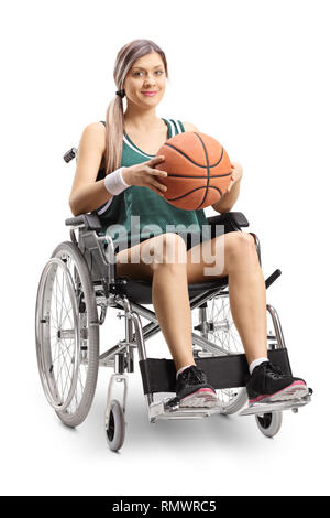 Full length shot of a woman in a wheelchair holding a basketball isolated on white background Stock Photo