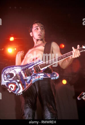 Lead guitarist, singer and songwriter Daron Malakian of the hard rock band System of a Down is shown performing on stage during 'live' concert appearance. Stock Photo