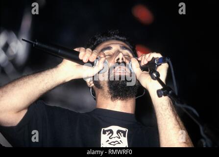Singer Serj Tankian of the hard rock band System of a Down is shown performing on stage during 'live' concert appearance. Stock Photo