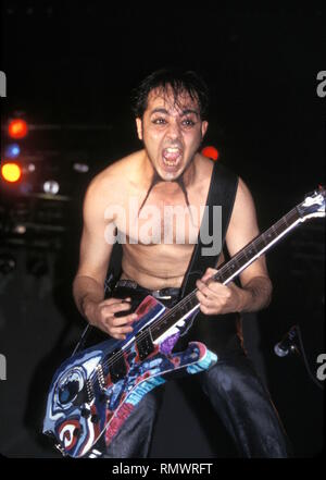 Lead guitarist, singer and songwriter Daron Malakian of the hard rock band System of a Down is shown performing on stage during 'live' concert appearance. Stock Photo