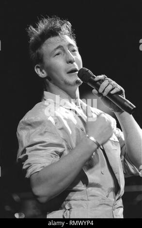 Singer, songwriter, musician, and first son of Beatle John Lennon, Julian Lennon is shown performing on stage during a 'live' concert appearance. Stock Photo