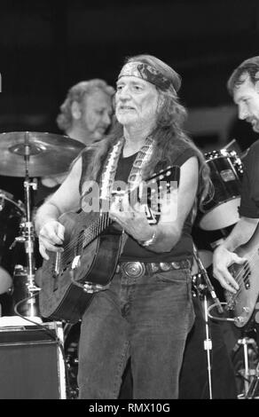 Country music star Willie Nelson is shown performing on stage during a 'live' concert appearance. Stock Photo