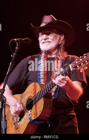 Country singer, songwriter author, poet and actor Willie Nelson is shown performing on stage during a 'live' concert appearance. Stock Photo