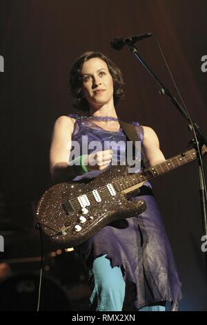 Singer, songwriter, record producer, and occasional actress Alanis Morissette is shown performing on stage during a 'live' concert appearance. Stock Photo