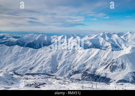 Snowy winter mountains in sun day. Caucasus Mountains, Georgia, from ski resort Gudauri Stock Photo