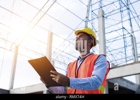 Engineer or inspector checking progressing work in construction site Stock Photo