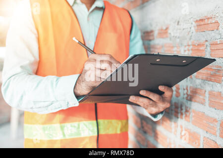 Engineer or inspector checking progressing work in construction site Stock Photo