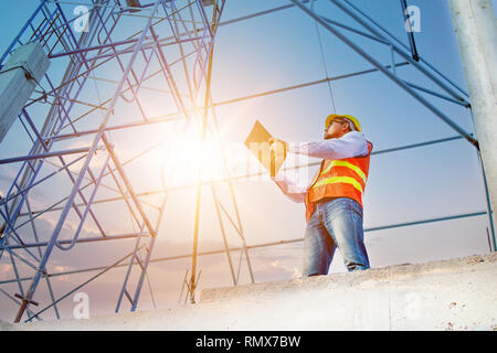 Engineer or inspector checking progressing work in construction site Stock Photo