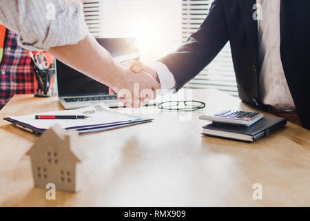 Real estate concept, businessman, investor shake hands with engineer, successful planning and meeting about home, house and  resident construction Stock Photo