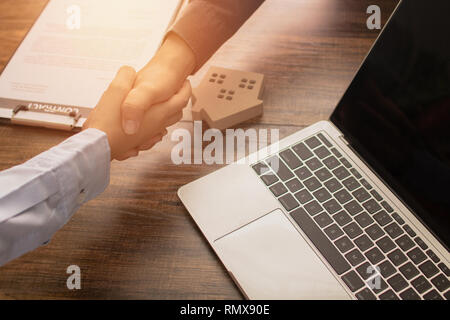 Real estate concept, Banker agency shake hand with client or house buyer after successful communication and sign contract Stock Photo
