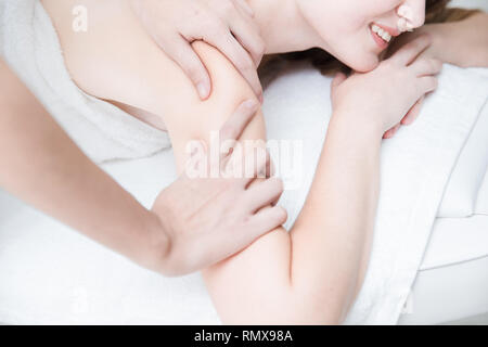 Women shoulder pain, enjoy rubbing massage for relaxation in spa Stock Photo
