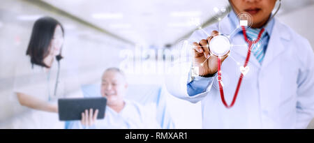 Horizontal banner of doctor holding stethoscope with medical icon with blur doctor woman introducing old patient background in hospital Stock Photo
