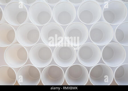 White single-use plastic cups top view as a background. Background pattern of group of plastic cups Stock Photo