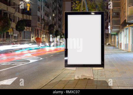 Blank advertisement billboard, with blurred traffic lights at night Stock Photo
