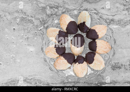 Homemade coconut and chocolate cookies on glass tray, gray background Stock Photo