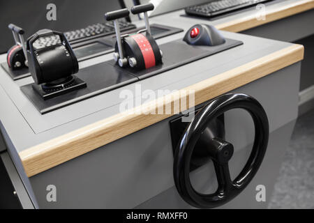 Small yacht control panel with steering wheel and engine accelerators on the captains bridge Stock Photo