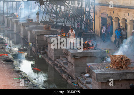 PASHUPATINATH, KATHMANDU, NEPAL-CIRCA 2013 : Hindu cremation process in progress at a temple in Pashupatinath, Nepal. Stock Photo