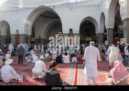 MEDINA, SAUDI ARABIA-CIRCA 2016 : Pilgrims pray inside Quba mosque in Medina. Quba mosque is the first mosque built by Prophet Mohammad (peace be upon Stock Photo