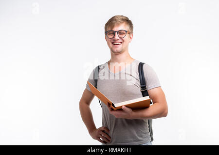 Education, university, people concept - male student wearing glasses opened a book and smiling on white background with copy space Stock Photo