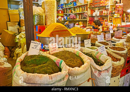 ISFAHAN, IRAN - OCTOBER 21, 2017: The bags with fragrant spices in front of the  stall of Grand Bazaar, on October 21 in Isfahan. Stock Photo