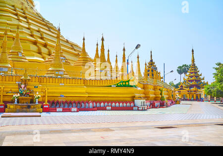 BAGO, MYANMAR - FEBRUARY 15, 2018: Walk around the ornate Shwemawdaw Paya, also named the Golden God Temple and famous as the tallest pagoda in countr Stock Photo