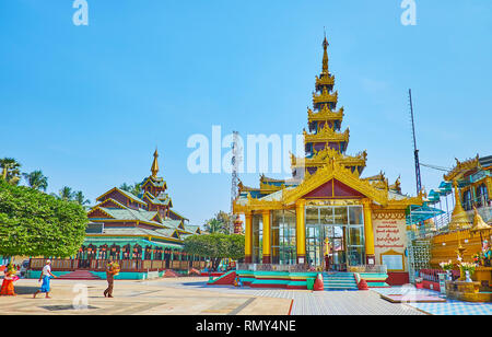BAGO, MYANMAR - FEBRUARY 15, 2018: The ornate shrines of Shwemawdaw Paya decorated with pyatthat (multitired) roofs, gilt and carved wooden patterns, 