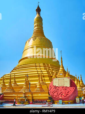 BAGO, MYANMAR - FEBRUARY 15, 2018: Panorama of the gilded stupa of Shwemawdaw Paya and the brick block at its foot, collapsed during the earthquake, o