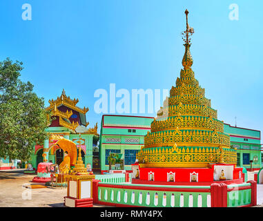 The colorful stupa, decorated with intricate gild pattern and topped with beautiful hti umbrella in Shwemawdaw Pagoda, Bago, Myanmar. Stock Photo