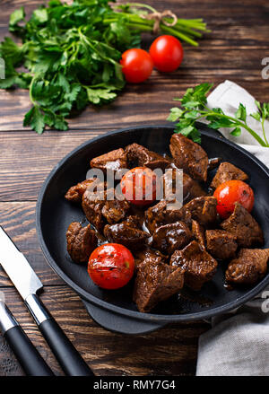 Roasted or stewed beef meat with tomato Stock Photo