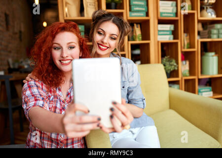 Two nice smile girls photographing themselves Stock Photo