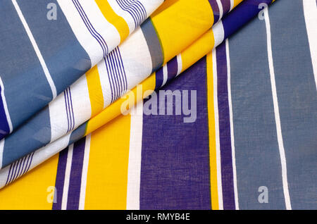 The texture of cotton fabric, batist in blue-white-yellow stripes Stock Photo